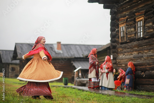 Traditional Slavic rituals in the rustic style. Outdoor in summer. Slavic village farm. Peasants in elegant robes. photo