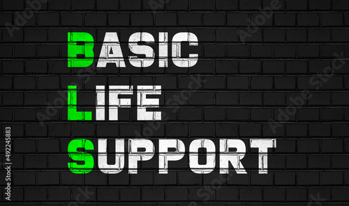 Basic life support(BLS) concept,healthcare abbreviations on black wall