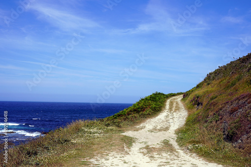 Dirt path on hill by the sea.