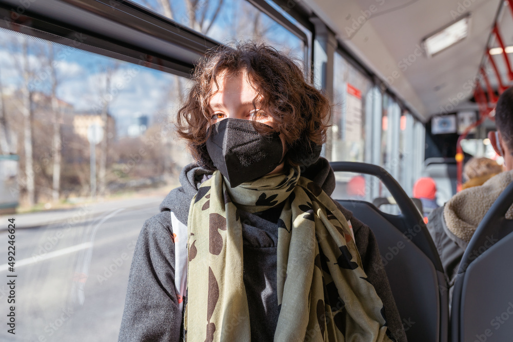 Traveling by city bus for students and schoolchildren in protective mask during pandemic