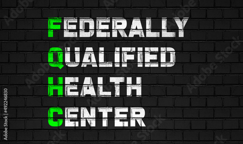 federally qualified health center (FQHC) concept,healthcare abbreviations on black wall photo