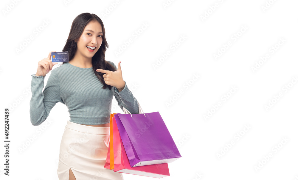 Cheerful beautiful girl holding shopping bags and showing credit card isolated over white background and copy space Young woman hold plastic credit card bags sale Pretty lady enjoys and like shopping Cheerful beautiful girl holding shopping bags and showing credit card isolated over white background and copy space Young woman hold plastic credit card bags sale Pretty lady enjoys and like shopping
