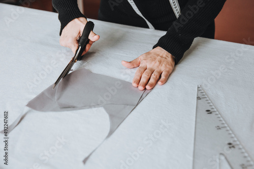 Tailor designer working of cutting piece of cloth with scissors, entrepreneur concept