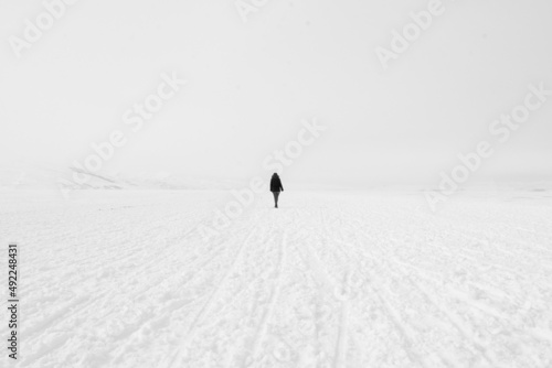 Woman walking in the middle of frozen lake Çıldır, Ardahan, Kars, Turkey country, minimalism infinity eternity walking in snow iced lake in ardahan turkey