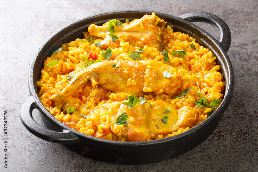 Fragrant rice with vegetables and rabbit meat close-up in a frying pan on the table. horizontal Fragrant rice with vegetables and rabbit meat close-up in a frying pan on the table. horizontal