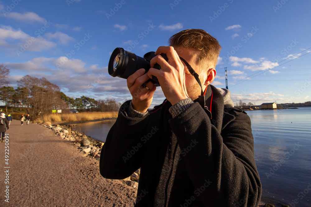 person taking pictures with professional camera