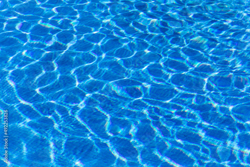 Beautiful blue water in a tiled pool reflecting sunlight and glistening