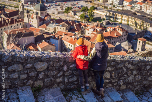 Mom and son travelers in Montenegro in Kotor Old Town Ladder of Kotor Fortress Hiking Trail. Aerial drone view