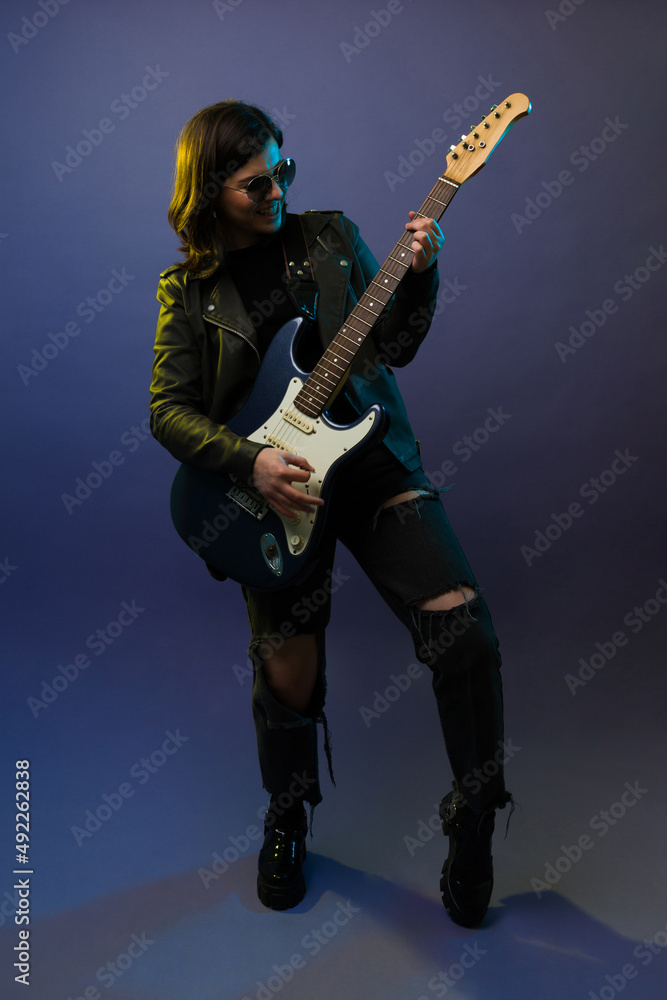 Happy rock musician rehearsing