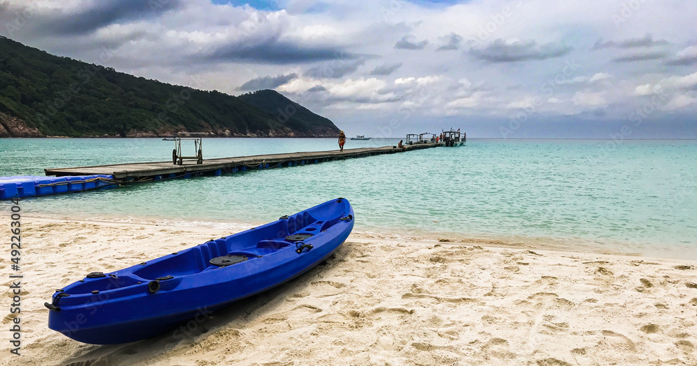 Redang Island, Malaysia Colourful blue kayak boat on the beach ready to be sailed early in the morning