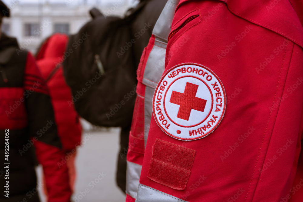 Foto Stock Lviv, Ukraine - March 8, 2022 : Red Cross mission help refugees  during conflict in Ukraine - emblem in Ukrainian. Selective focus | Adobe  Stock