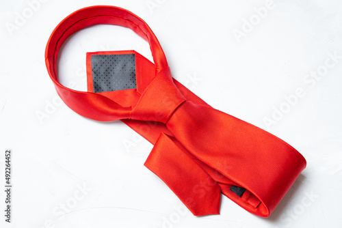 Canvas-taulu Tied red necktie on a concrete background