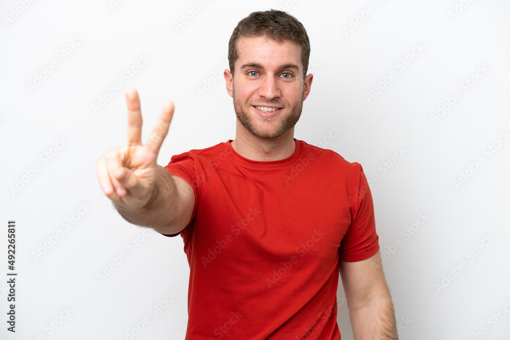 Young caucasian man isolated on white background smiling and showing victory sign Young caucasian man isolated on white background smiling and showing victory sign