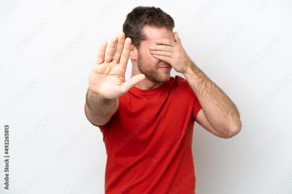 Young caucasian man isolated on white background making stop gesture and covering face Young caucasian man isolated on white background making stop gesture and covering face
