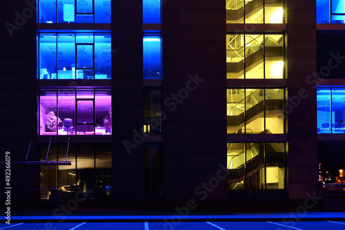 Modern office building with illuminated windows at night time