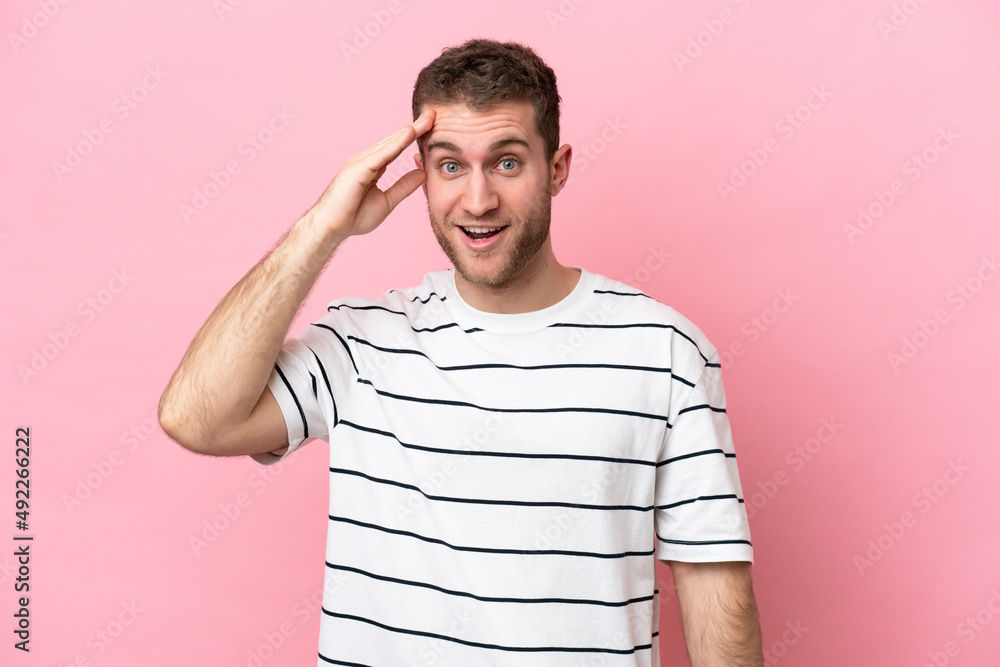 Young caucasian man isolated on pink background has realized something and intending the solution Young caucasian man isolated on pink background has realized something and intending the solution