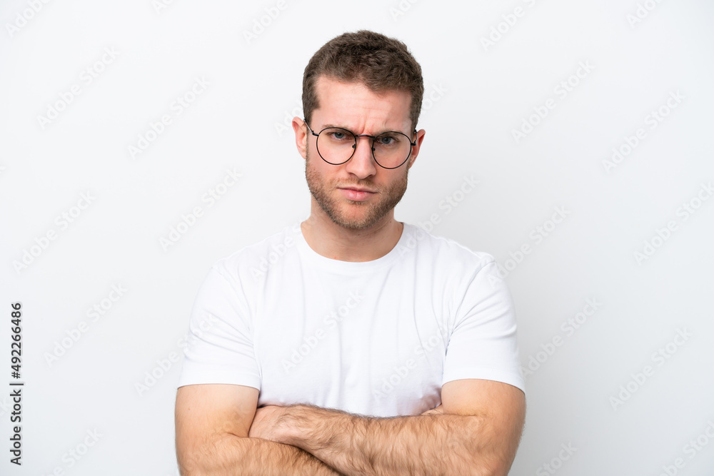 Young caucasian man isolated on white background With glasses and arms crossed Young caucasian man isolated on white background With glasses and arms crossed