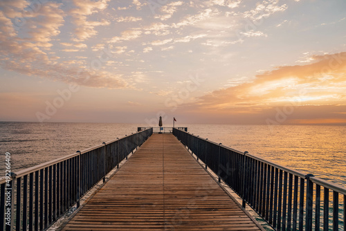 Beautiful sunrise over the ocean with a footbridge in Makadi Bay, Egypt