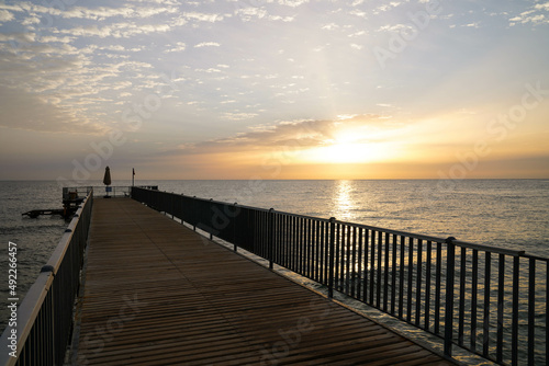 Beautiful sunrise over the ocean with a footbridge in Makadi Bay  Egypt