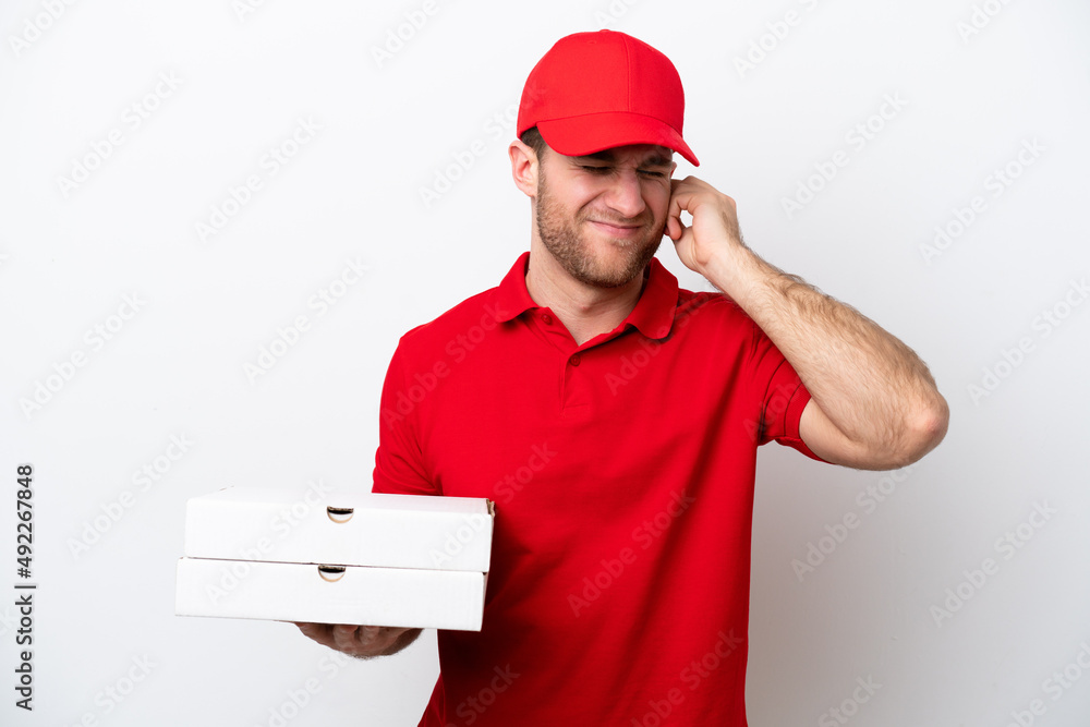 Pizza delivery caucasian man with work uniform picking up pizza boxes isolated on white background frustrated and covering ears Pizza delivery caucasian man with work uniform picking up pizza boxes isolated on white background frustrated and covering ears