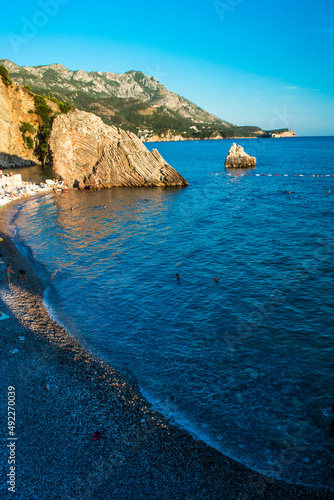 Beautiful rocks on pebble public stone beach. Rafailovici esort towns. Mountenegro. Adriatic Sea. photo