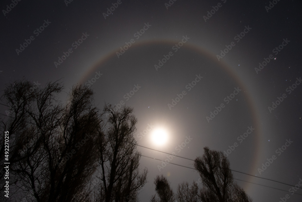 Halo phenomenon on the moon over Ukraine at night during the war in the country 2022, night moon and stars
