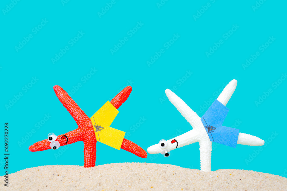 Starfish characters handstanding on the beach Starfish characters handstanding on the beach