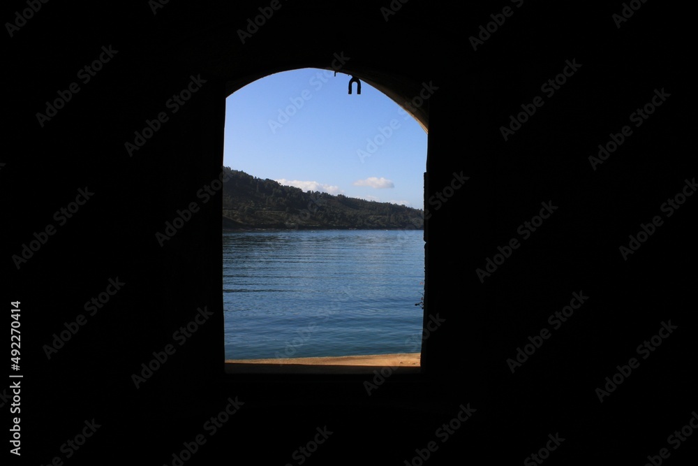 Window of a castle looking to the sea and the montains. Window of a castle looking to the sea and the montains.