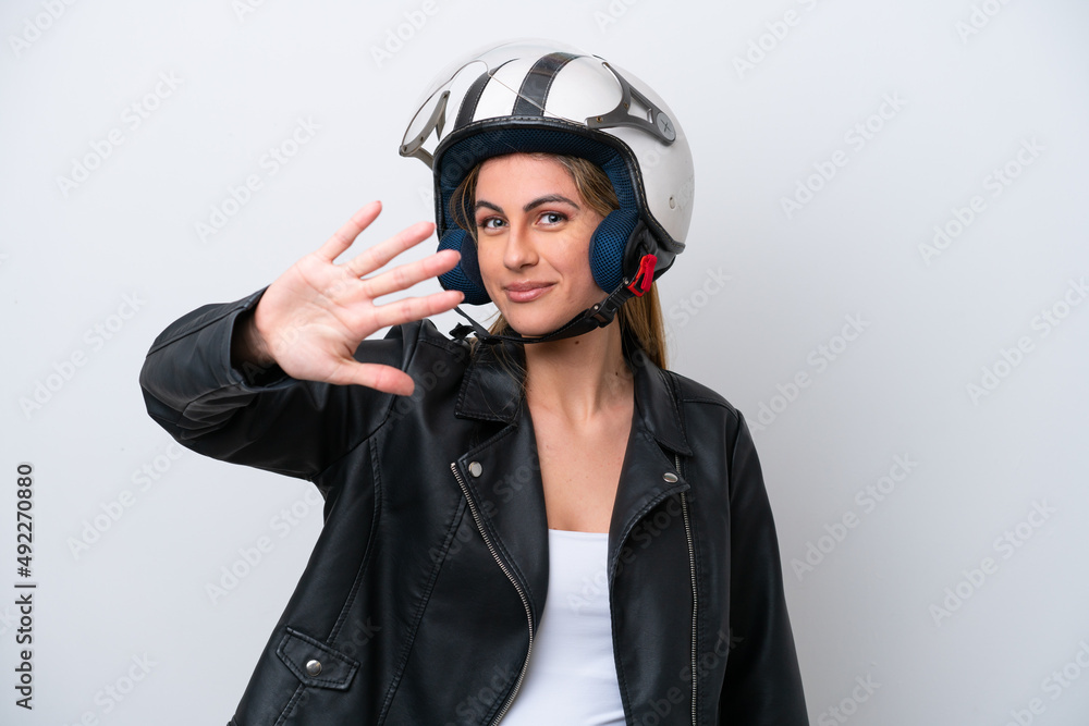 Young caucasian woman with a motorcycle helmet isolated on white background counting five with fingers Young caucasian woman with a motorcycle helmet isolated on white background counting five with fingers