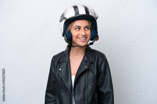 Young caucasian woman with a motorcycle helmet isolated on white background looking side © luismolinero