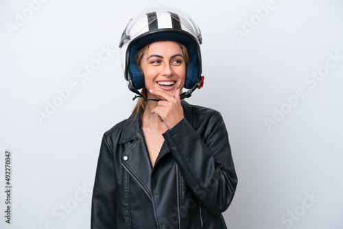 Young caucasian woman with a motorcycle helmet isolated on white background looking to the side and smiling © luismolinero