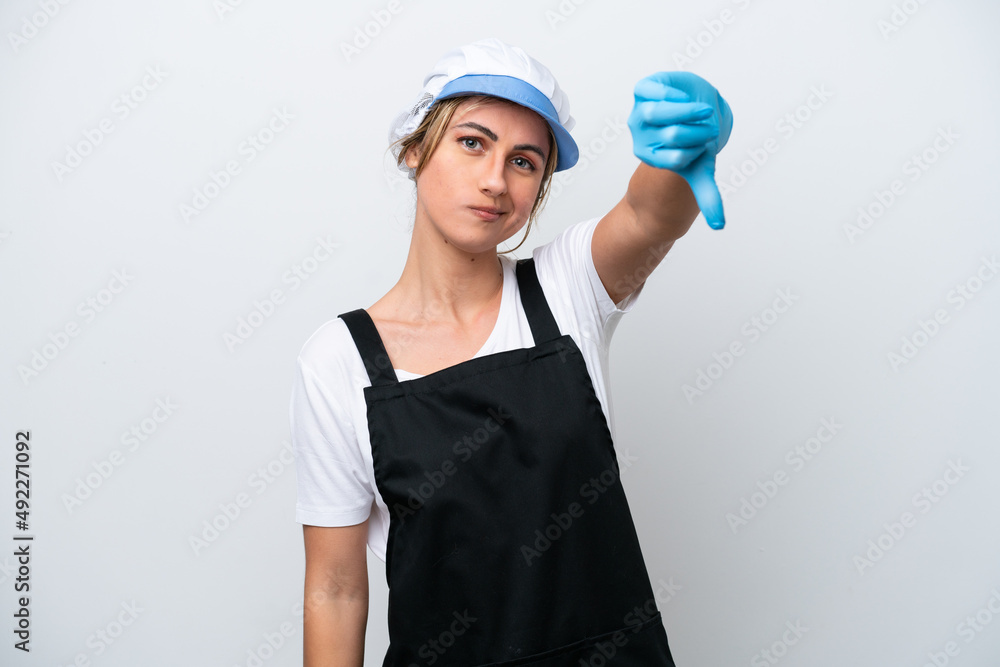 Fishwife woman isolated on white background showing thumb down with negative expression Fishwife woman isolated on white background showing thumb down with negative expression