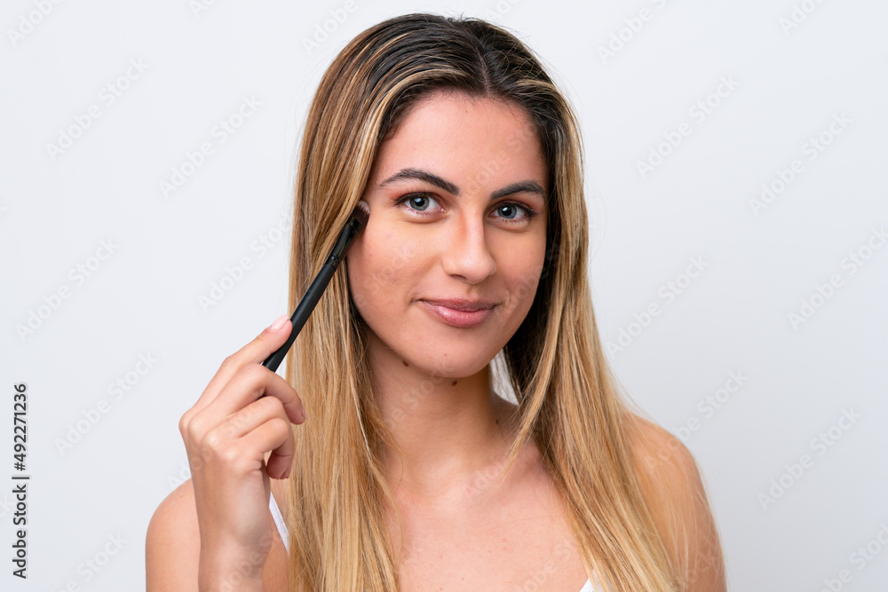 Young caucasian woman isolated on white background holding makeup brush Young caucasian woman isolated on white background holding makeup brush