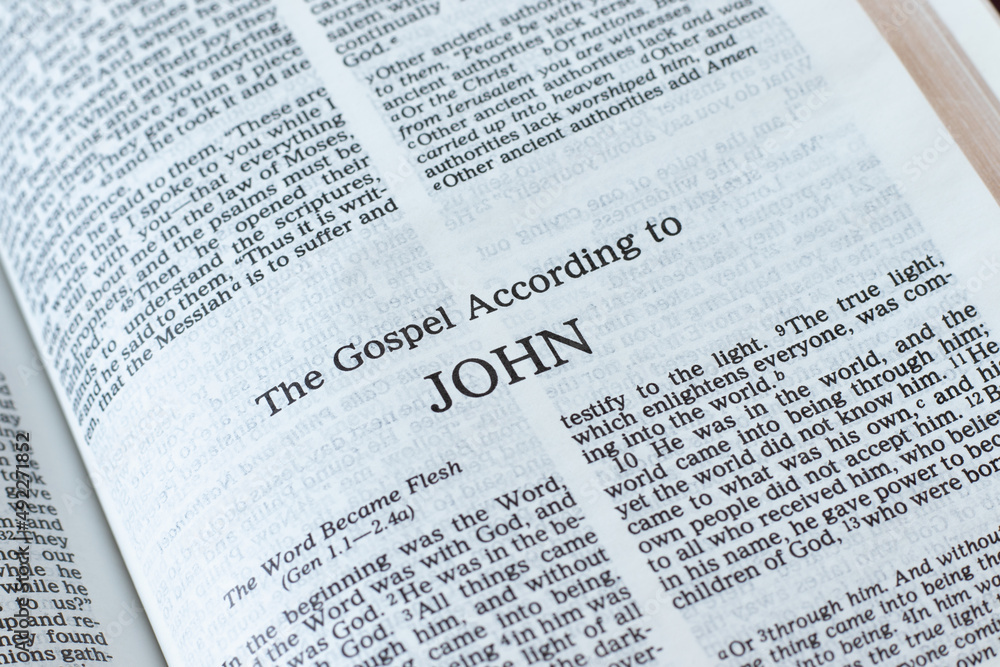 John Gospel open Holy Bible Book inspired by God Jesus Christ. Christian biblical concept of love and faith. Life and teaching of our Savior and Messiah. A closeup. John Gospel open Holy Bible Book inspired by God Jesus Christ. Christian biblical concept of love and faith. Life and teaching of our Savior and Messiah. A closeup.