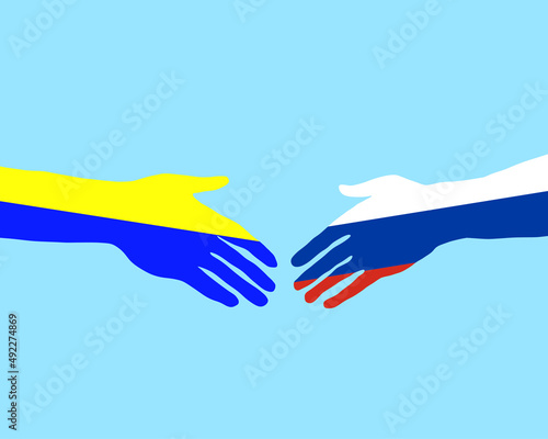 Hand mit Ukraine Fahne und Hand mit Russland Fahne nähern sich an photo
