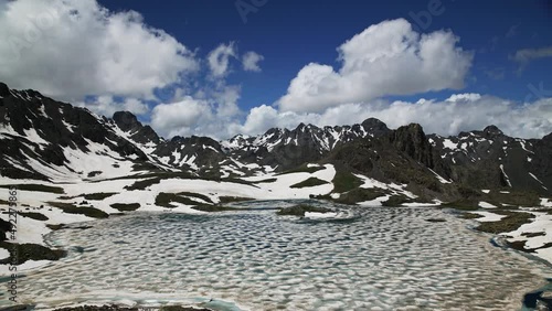 Wallpaper Mural 4K Time Lapse. Glacial lake on top of snowed mountains. Clouds Time Lapse. Torontodigital.ca