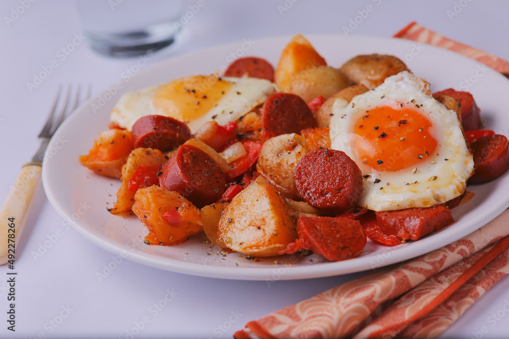 Chorizo and Spanish eggs with potatoes and mixed onions and peppers. Chorizo and Spanish eggs with potatoes and mixed onions and peppers.