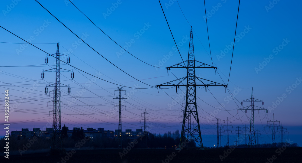 power line pylons after sunset