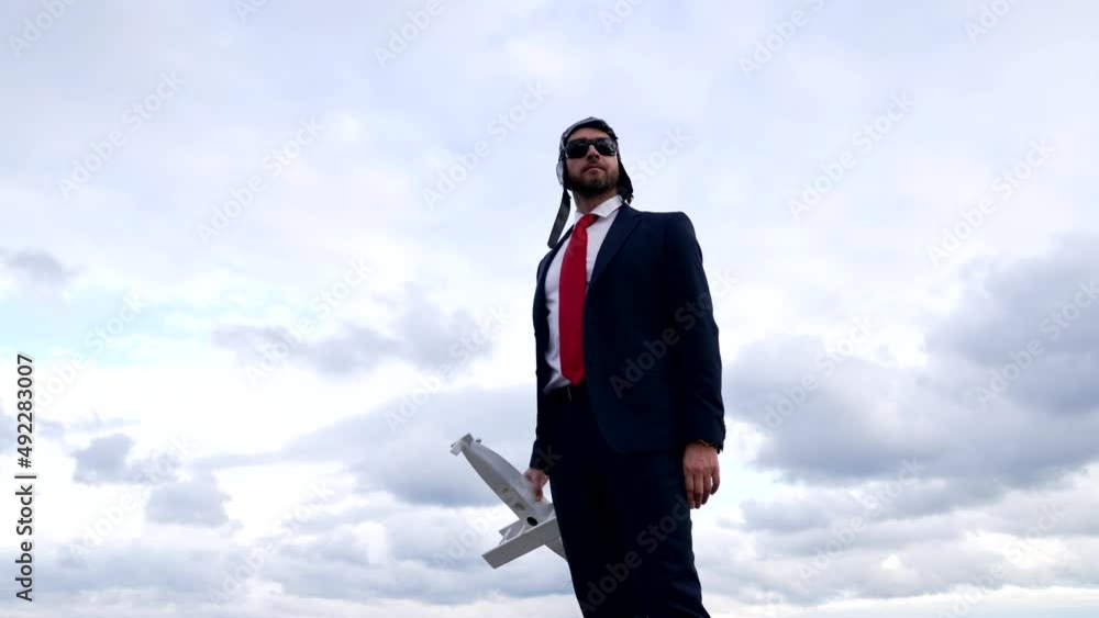 businessperson in suit and pilot hat with glasses hold plane, business trip businessperson in suit and pilot hat with glasses hold plane, business trip
