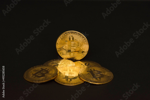 Bitcoin BTC crypto currency gold coins on black background, new virtual money concept. Mining or blockchain technology