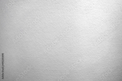 White background made of soft felt fabric.Rag light background with fine white hairs.