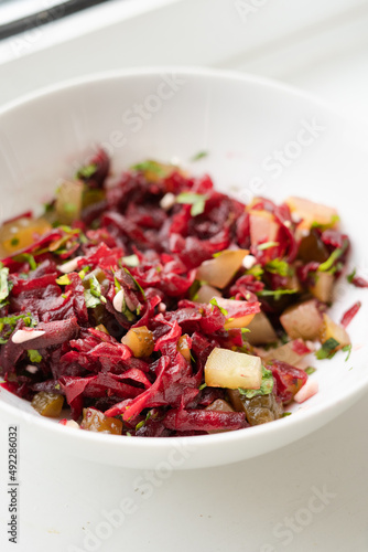 Raw salad with grated cooked beetroot and pickled cucumber, healthy diet, vegan, vegetarian