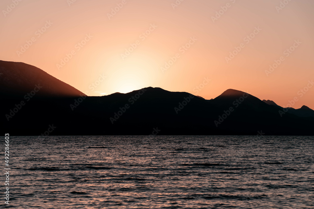 the outline of the mountains at sunset, the shore of the adriatic sea in croatia, summer sunset by the sea