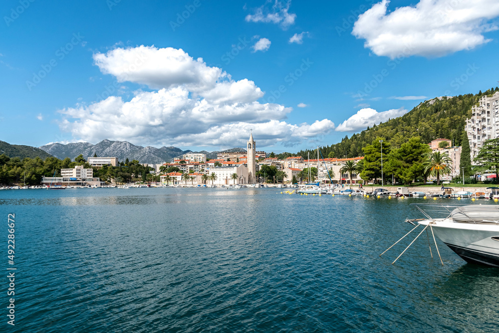 Naklejka premium church in Ploce in Croatia, center of the city Ploce, promenade in Ploce, summer cityscape, blue and cloudy sky