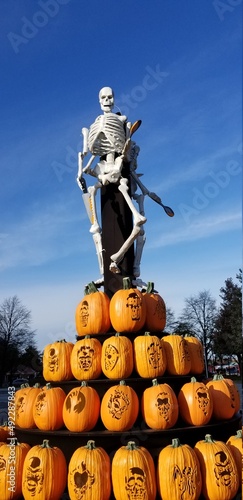 skeleton on tower of pumpkins