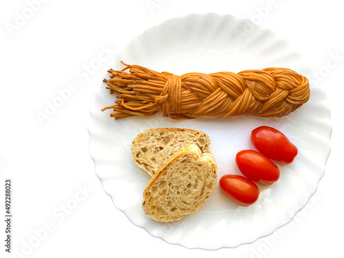 Cheese braid, two slices of bread and cherry tomatoes, isolated on white photo