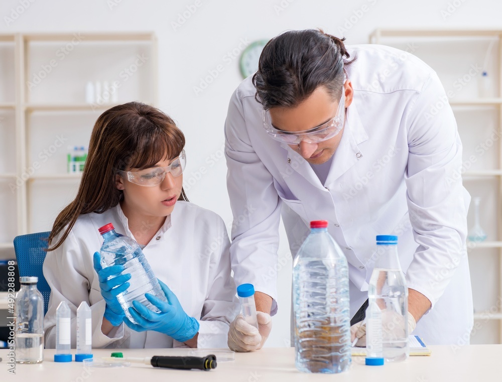 Two chemists working in the lab