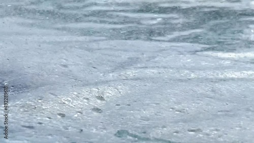 Raindrops falling on the surface. Close-up rain droplets