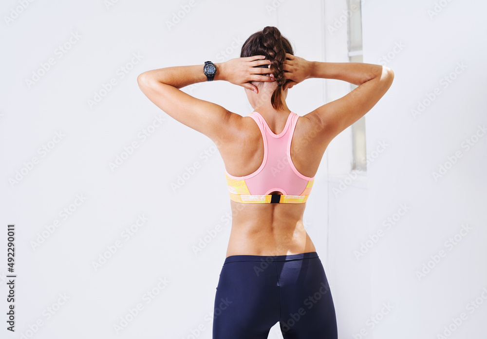 Use your body. Rearview shot of an attractive young woman stretching for a workout. Use your body. Rearview shot of an attractive young woman stretching for a workout.