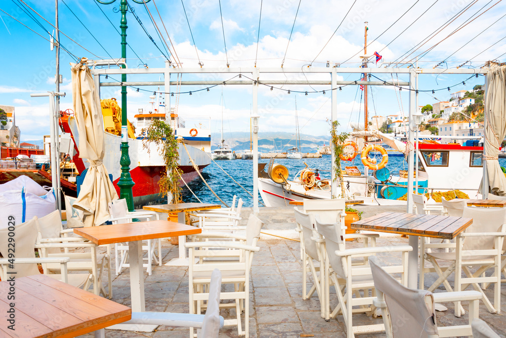 View from a waterfront sidewalk cafe of the sea and boats in the harbor at the small island and village of Hydra, Greece.	